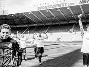 Footballers walking off the pitch at St James' Park