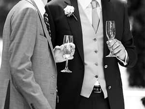 An image of two men at a wedding holding champagne flutes