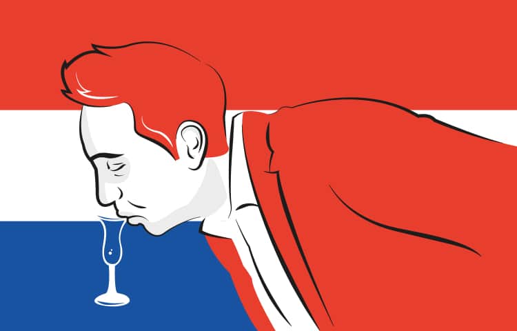 An illustration of a man in a red blazer, bending down over a table to take a sip of his drink