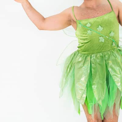 A man dancing in a green Tinkerbell costume