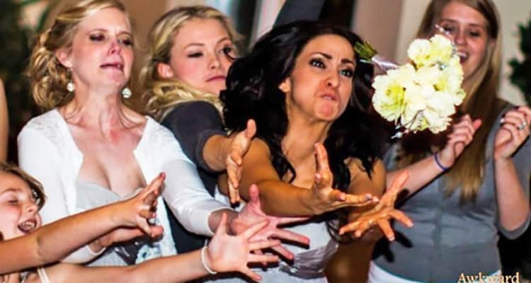women desperately trying to catch bouquet at wedding