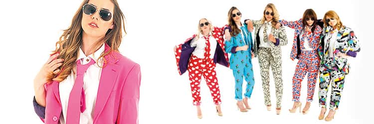 A close up of a woman in a pink blazer and white shirt, and five women in Opposuits
