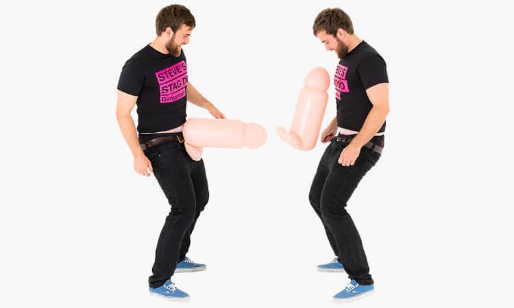 A mirror image of a man in black with an inflatable cock around his waist