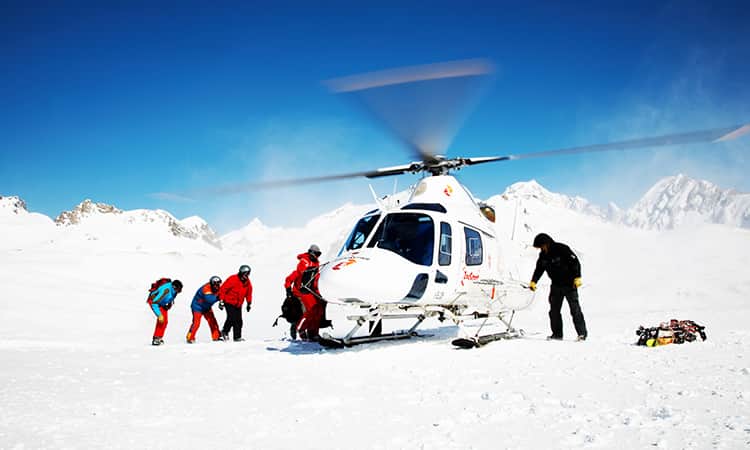 Group getting off a helicopter on the ice of the North Pole.