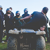 A group of LNOF staff listening to a quad bike instructor