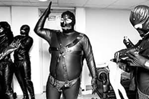 Staff getting dressed up in our very own gimp outfits for their 15 seconds of fame
