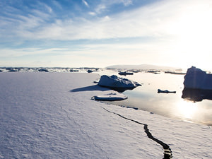 Image of ice and water with a blue sky. 
