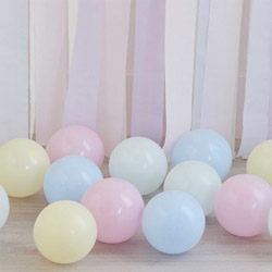 Pastel yellow, green, blue, and pink balloons against a multi coloured backdrop.