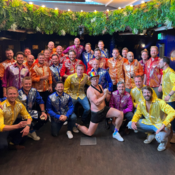 A group of men on a stag do dressed in matching Stand Out shirts