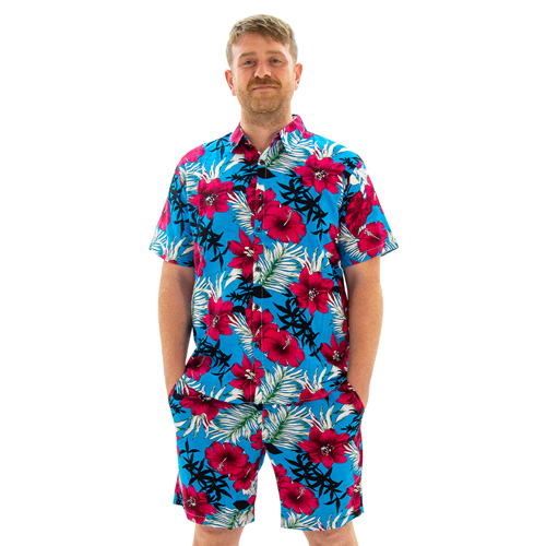 A model wearing Sky Blue Hawaiian Shirt and Shorts, facing the camera with his hands in his pockets.