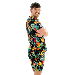 Model posing in Black Hawaiian Shirt and Shorts, to the side with his arms crossed.
