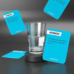 Shot glass and game cards on a black back drop.