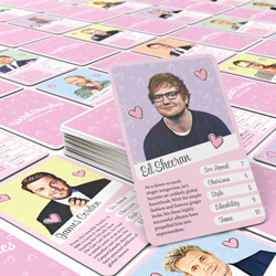 Weird Crushes British Edition cards laid out on a table with Ed Sheerans card on top.