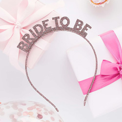 Rose Gold Glitter Bride to Be Headband surrounded by gifts on a party table.