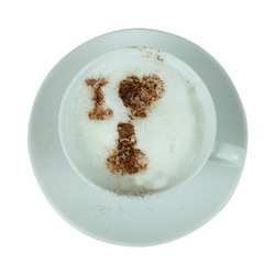 Offensive stencil design on top of a mug of coffee.