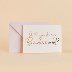 Will You Be My Bridesmaid card and envelope against a yellow background.