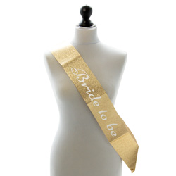 Gold Bride to Be sash on a mannequin isolated on a white background.
