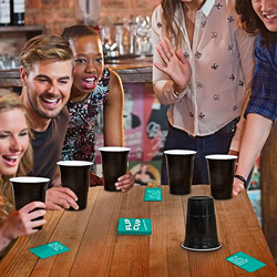 A group of friends playing flip cup in a pub.
