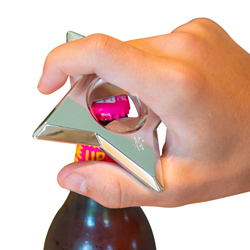 A man opening a bottle using the Ninja Dart Bottle Opener on a white background