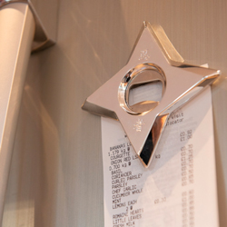 Ninja Dart Bottle Opener pinning a receipt to a fridge