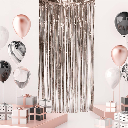 Rose gold curtain surrounded by balloons