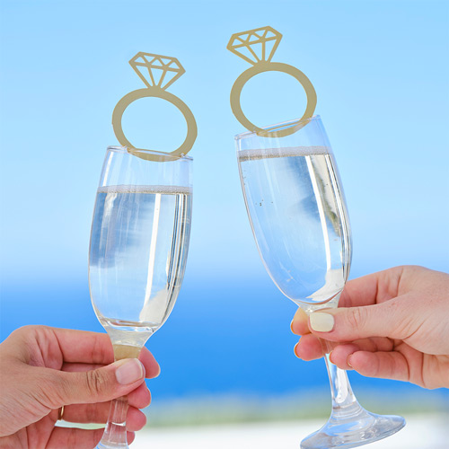Two ring drink toppers on two champagne glasses outside