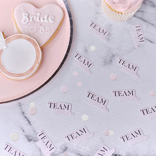 Team bride paper confetti spread over a table
