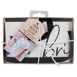 A box with a white bride sash with black ribbon in it