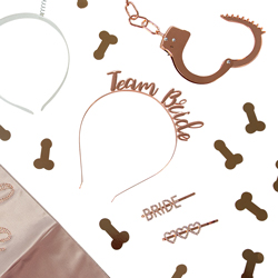 A flatlay of rose gold hen party accessories isolated on a white background