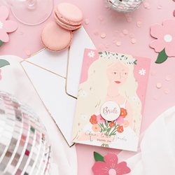Cheers to the Bride Enamel Pin with Card on a pink background surrounded by confetti