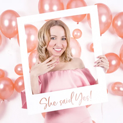 Bride to be posing with She Said Yes Photobooth Frame