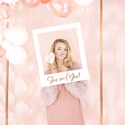 Woman to be posing with She Said Yes Photobooth Frame