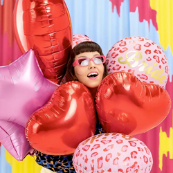Woman holding a collection of balloons including Bride Animal Print Foil Balloon