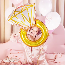 Woman holding She Said Yes Balloon Set on a pink bed