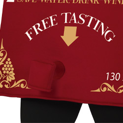 The bottom of a wine box themed stag do costume that reads free tasting with an arrow pointing downwards to a valve giving a risqué effect 