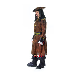 A male model stood to the side with a wig and moustache wearing a pirate costume consisting of a brown hat, long brown jacket, black/red striped trousers and boot tips 