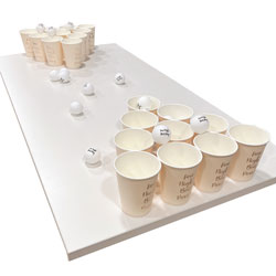 The Hen Party Beer Pong cups and balls set up on on a table on a white background.