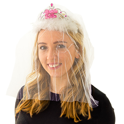 A girl wearing a Bride to Be veil and smiling at the camera