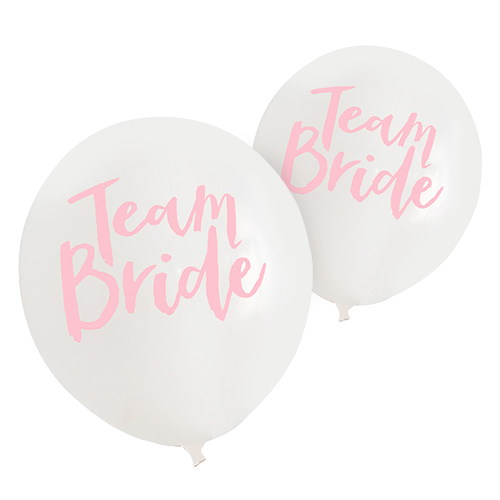 White balloons with team bride written in pink.