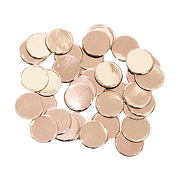Some rose gold discs laid out on a white surface