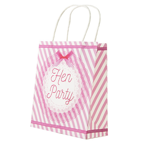 A pink and white hen party bag with a rosette on the front