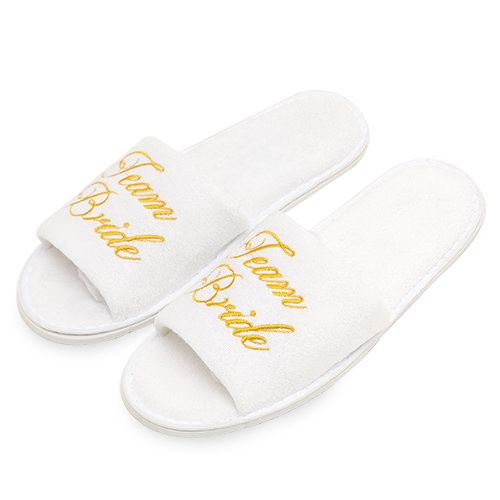 White slippers with team bride embroidered in gold.