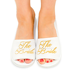 Gold embroidery on white slippers.