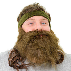 A man wearing a fake beard and mullet attached to a headband 