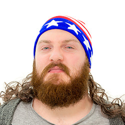 A man looking really angry and wearing a hat with attached mullet