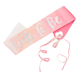 Bright pink bride to be sash with silver foil text.