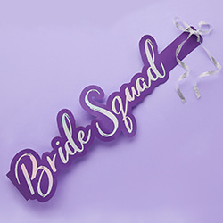 The bride squad sash against a purple background.