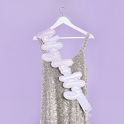 The sash shown on a dress hanging up on a coat hanger.