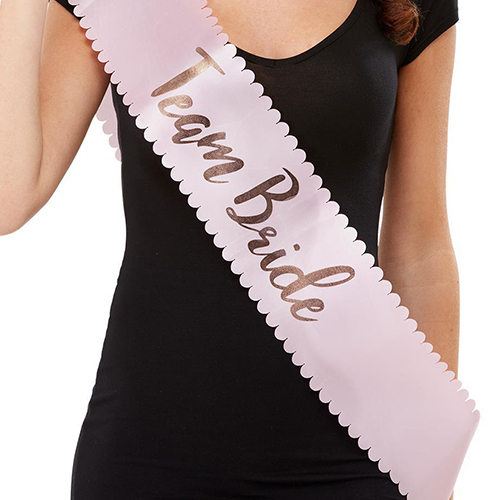 A model wearing the pink team bride sash.