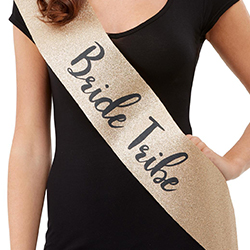 A gold glittery bride tribe sash worn by a model.